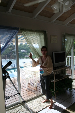 Jennie cleaning the window at Villa Time Out so she can get the perfect shot!